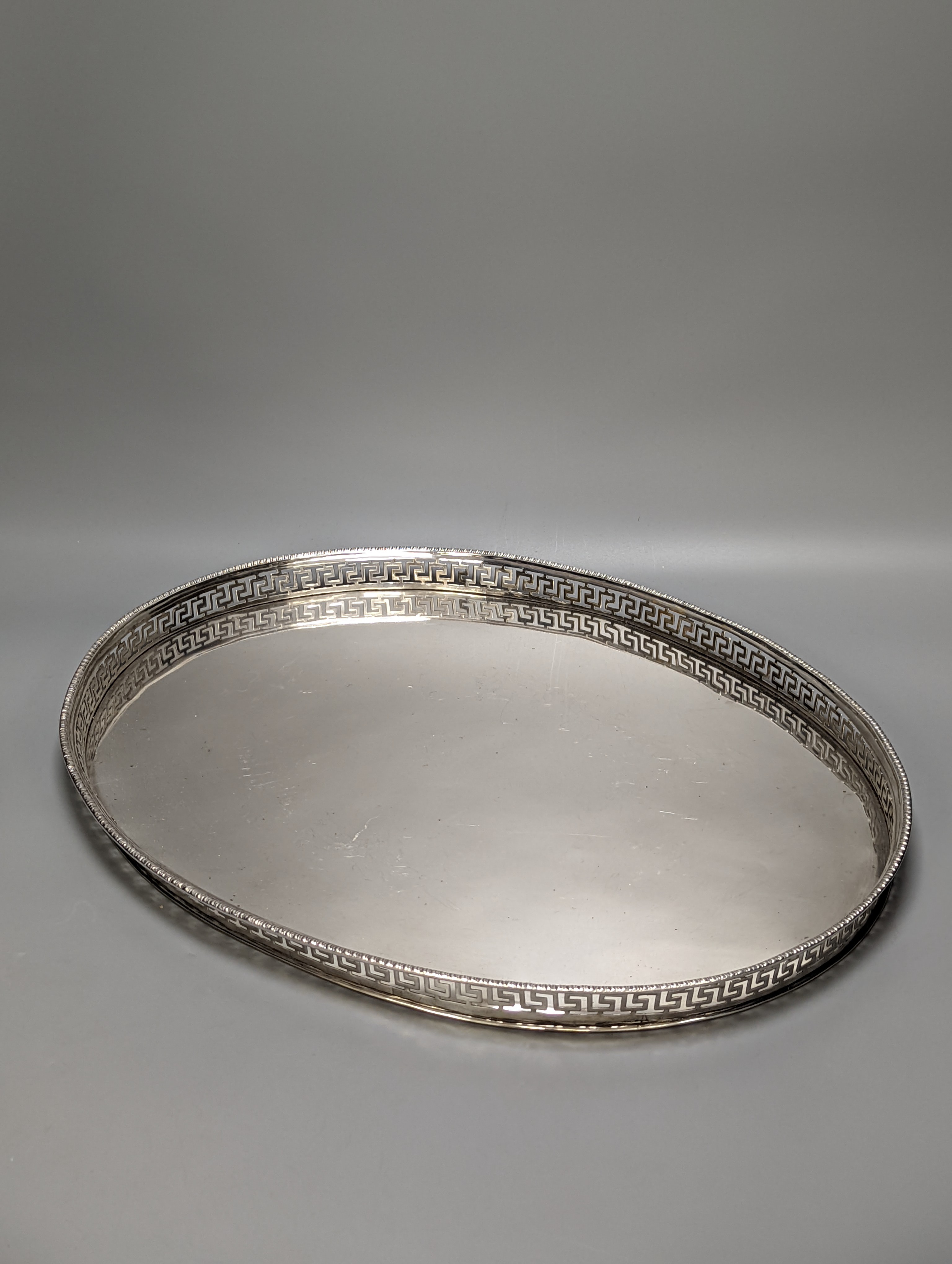 A Persian? white metal oval gallery tray, 45.7cm and an Italian 800 standard two handled oval tea tray